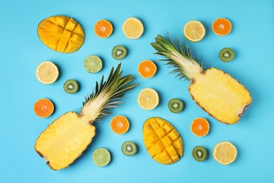 Photo of Different ripe fruits on light blue background, flat lay