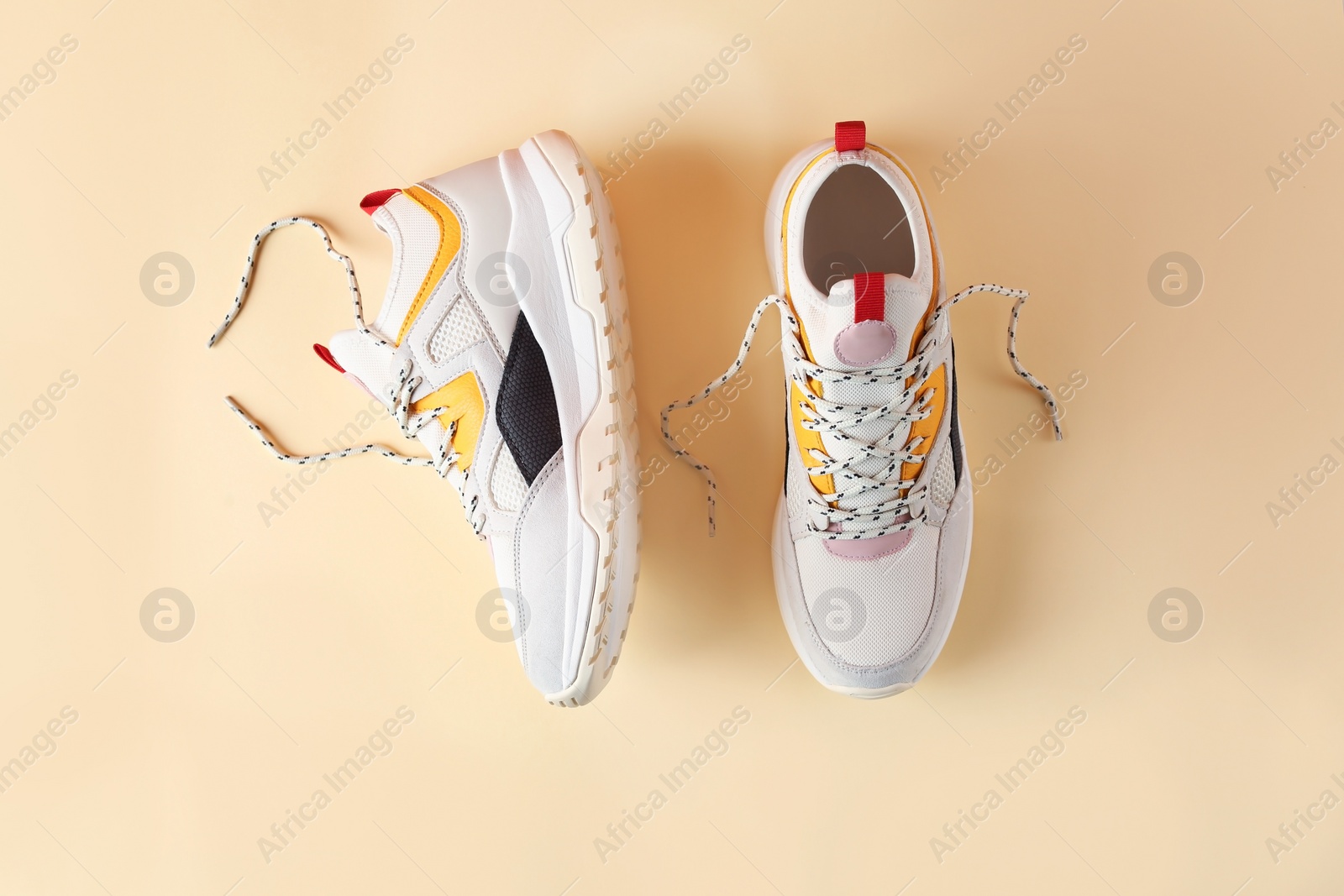 Photo of Pair of stylish sneakers on color background, top view