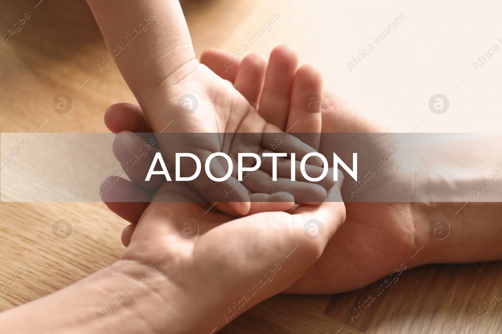 Image of Happy family holding hands on wooden background, closeup. Child adoption concept