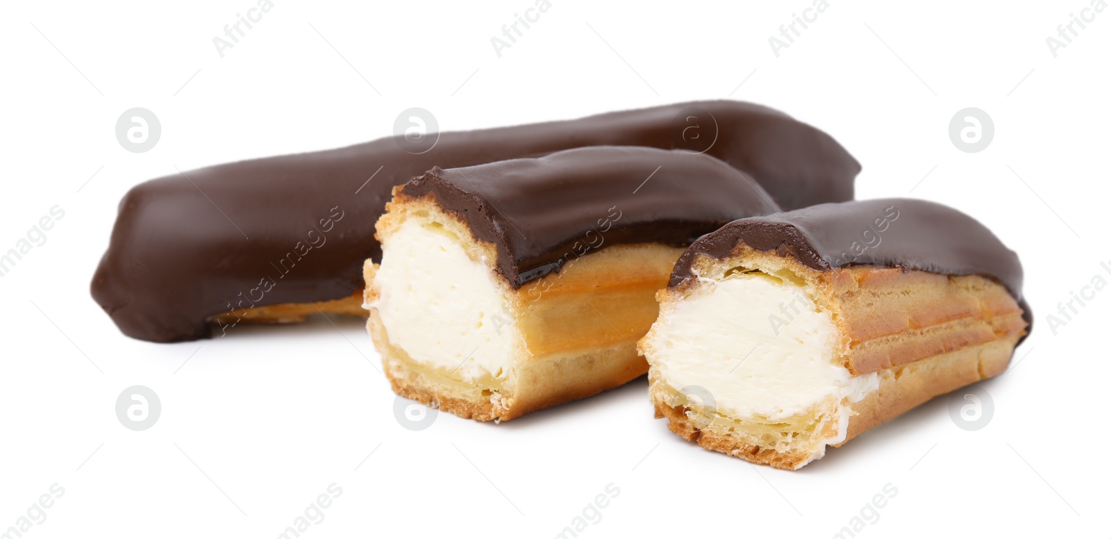 Photo of Cut and whole delicious eclairs covered with chocolate isolated on white