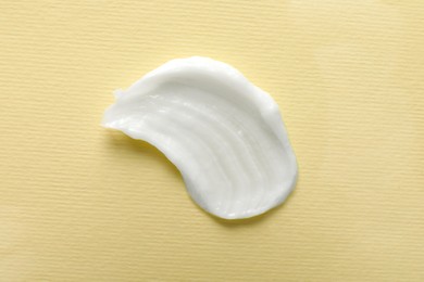 Photo of Smear of ointment on beige background, top view