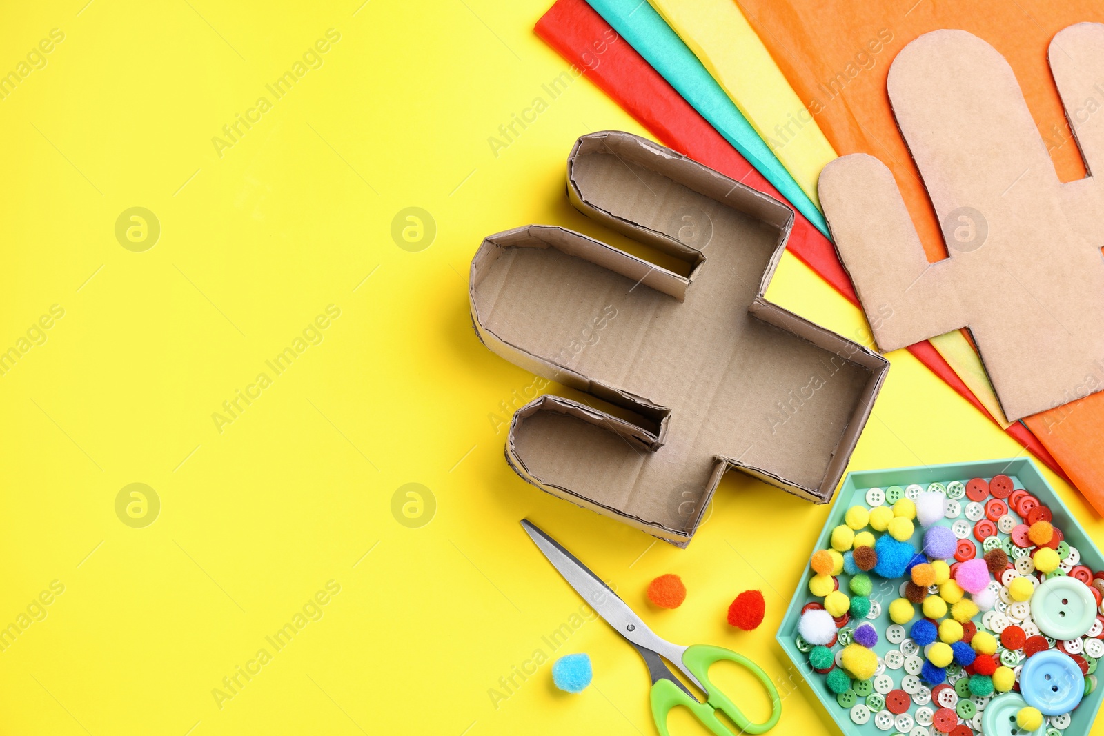 Photo of Materials and tools on yellow background, flat lay with space for text. Cactus pinata DIY