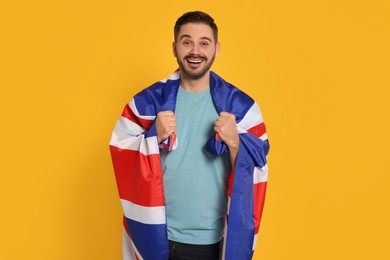 Man with flag of United Kingdom on yellow background