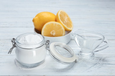 Jar with baking soda and lemons on light table