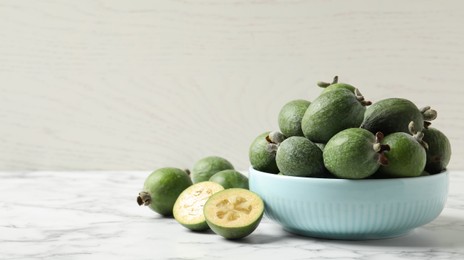 Image of Fresh green feijoa fruits on white marble table, space for text. Banner design