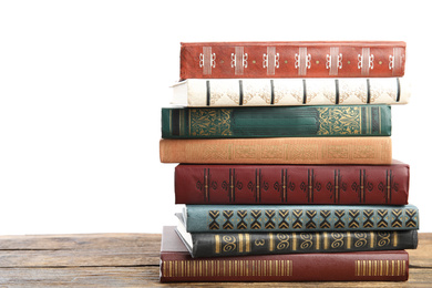 Photo of Stack of old vintage books on wooden table against white background