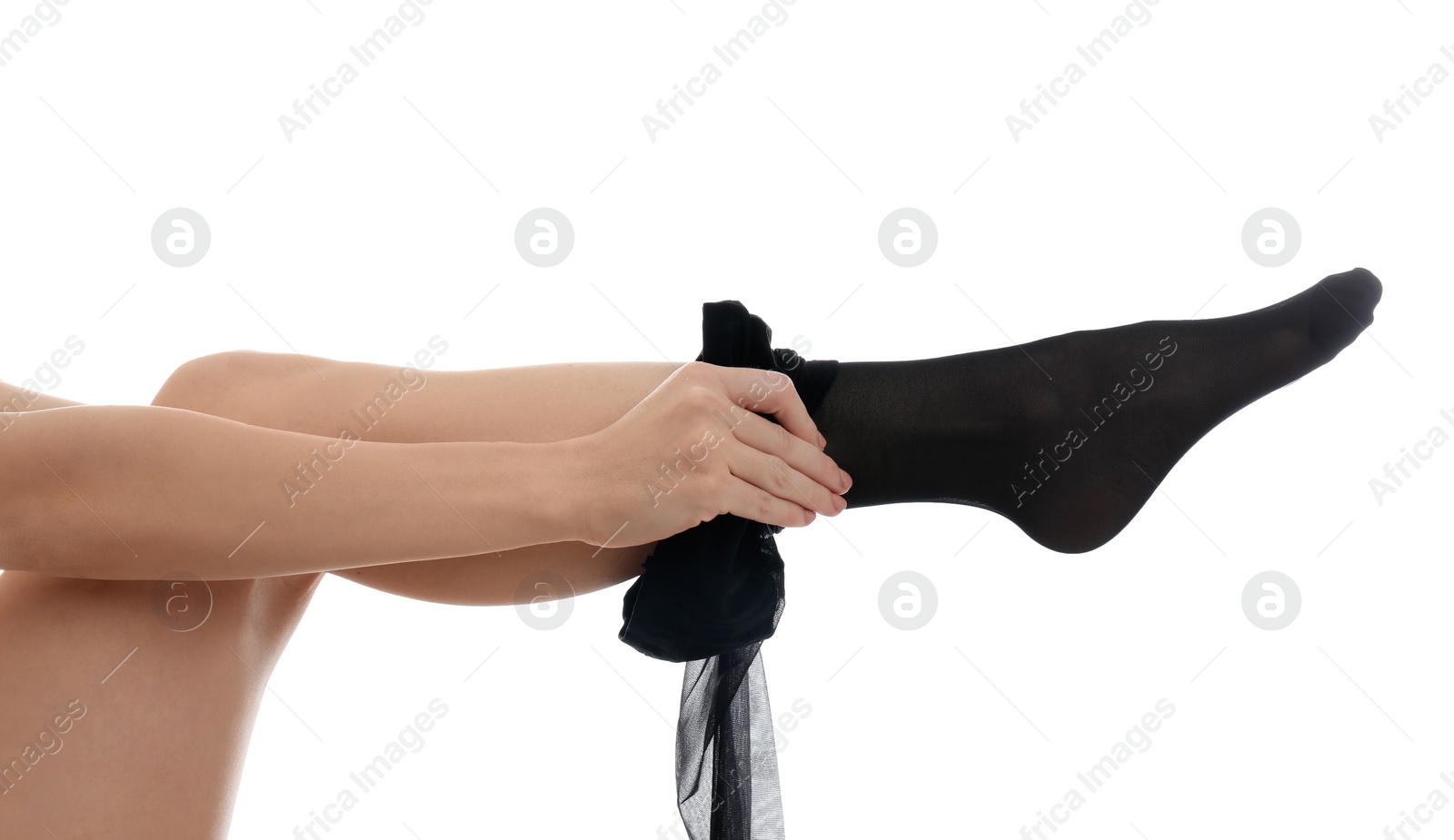 Photo of Young woman putting on tights against white background, closeup