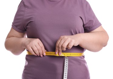 Photo of Overweight woman measuring waist with tape on white background, closeup