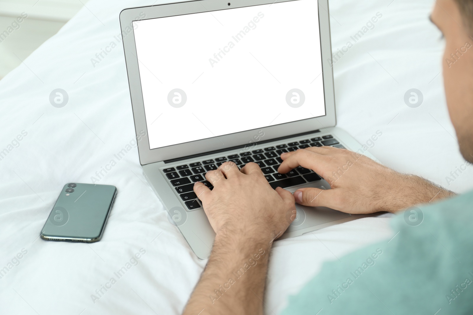 Photo of Man working on modern laptop at home, closeup