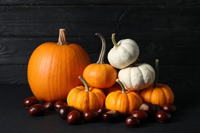 Photo of Thanksgiving day. Beautiful composition with pumpkins on black table