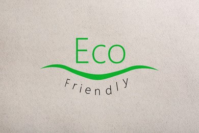 Image of Phrase Eco Friendly written on recycled paper, top view