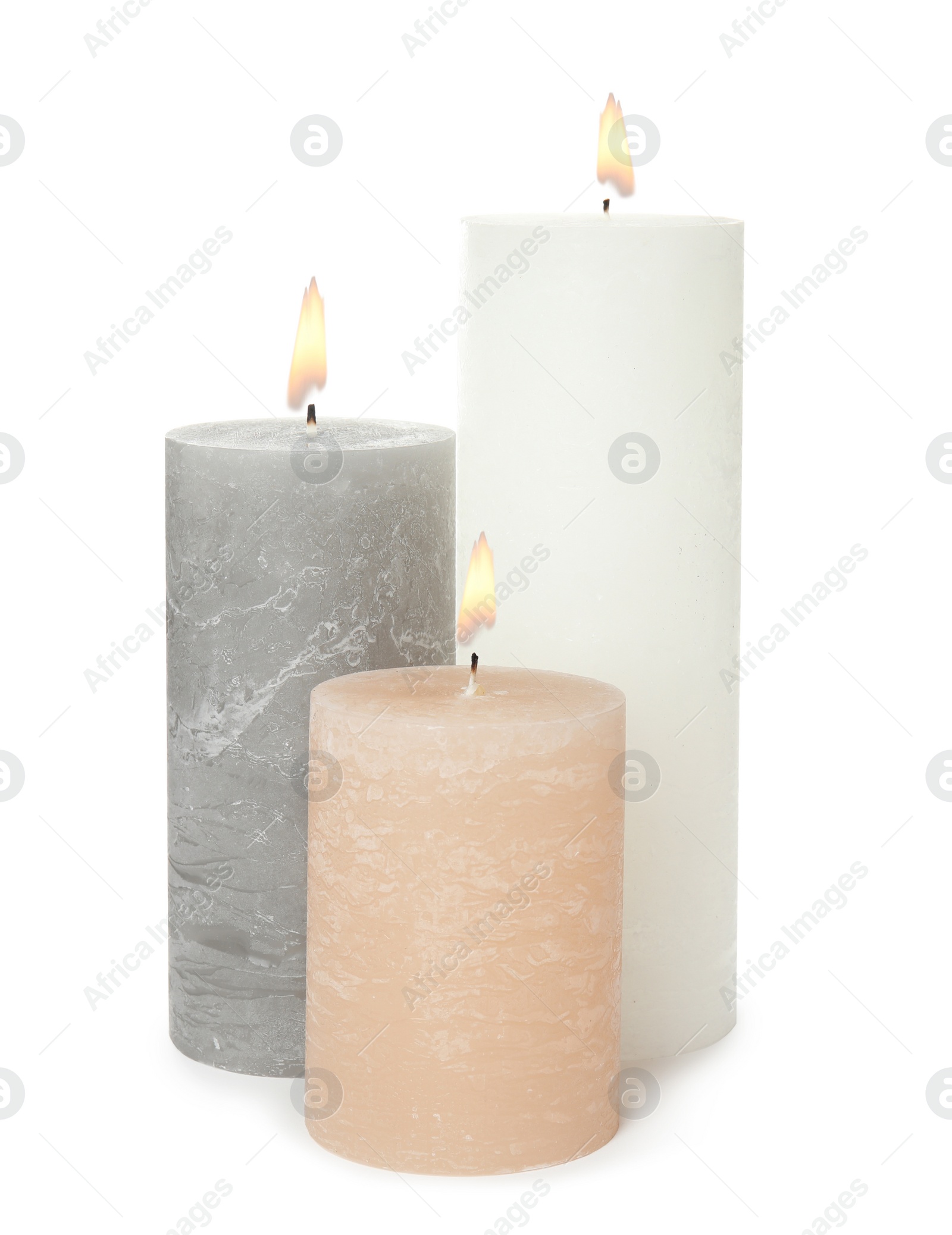 Photo of Three alight wax candles on white background