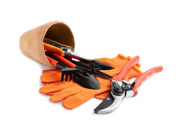 Photo of Pair of gloves and gardening tools on white background