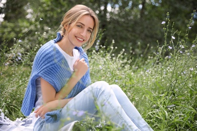 Photo of Portrait of beautiful young woman on green grass in park