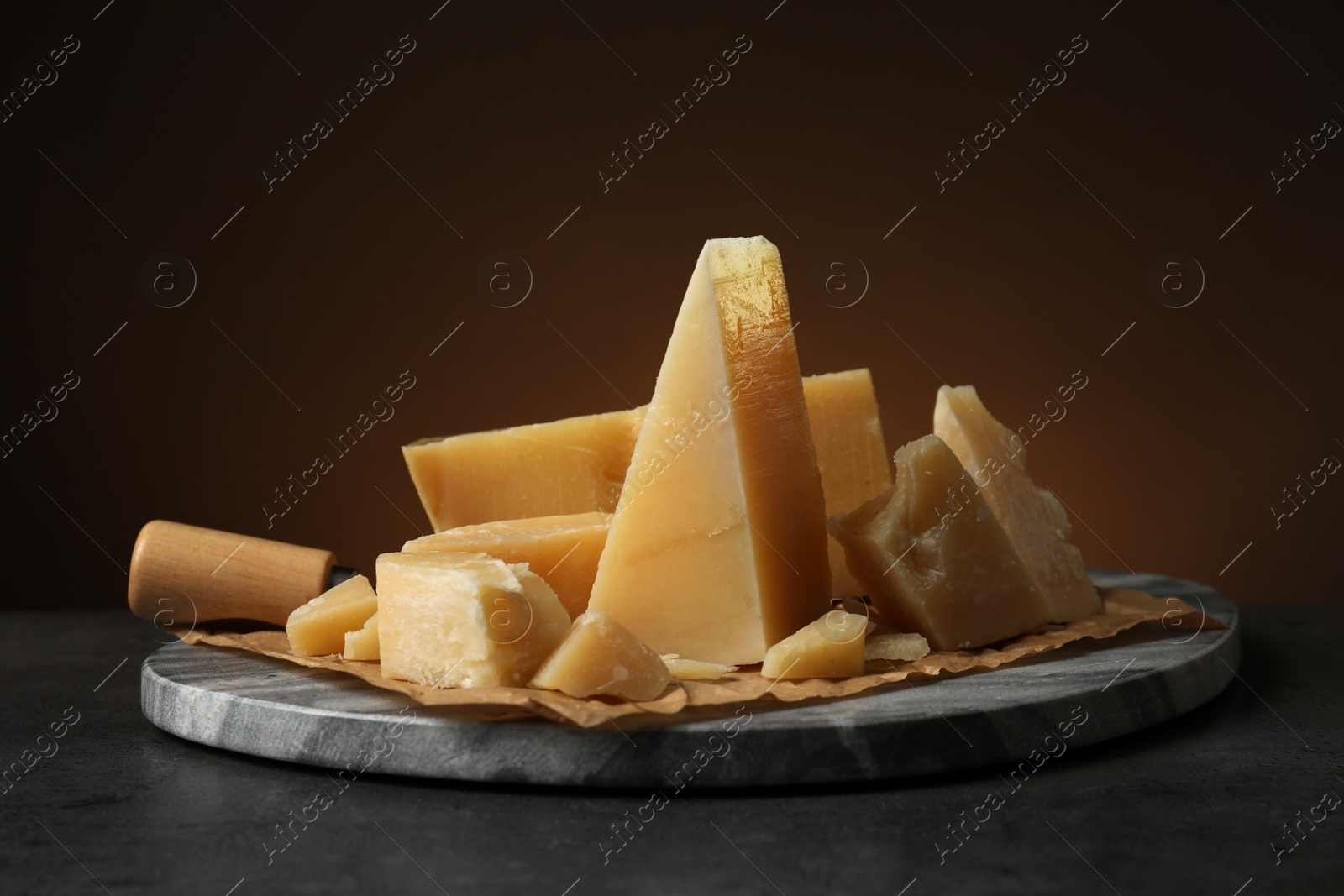 Photo of Marble board with delicious cheese on table