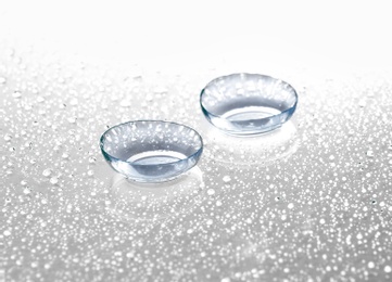 Contact lenses on wet background