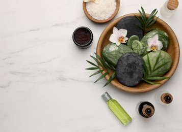 Photo of Flat lay composition with different spa products and flowers on white marble table. Space for text