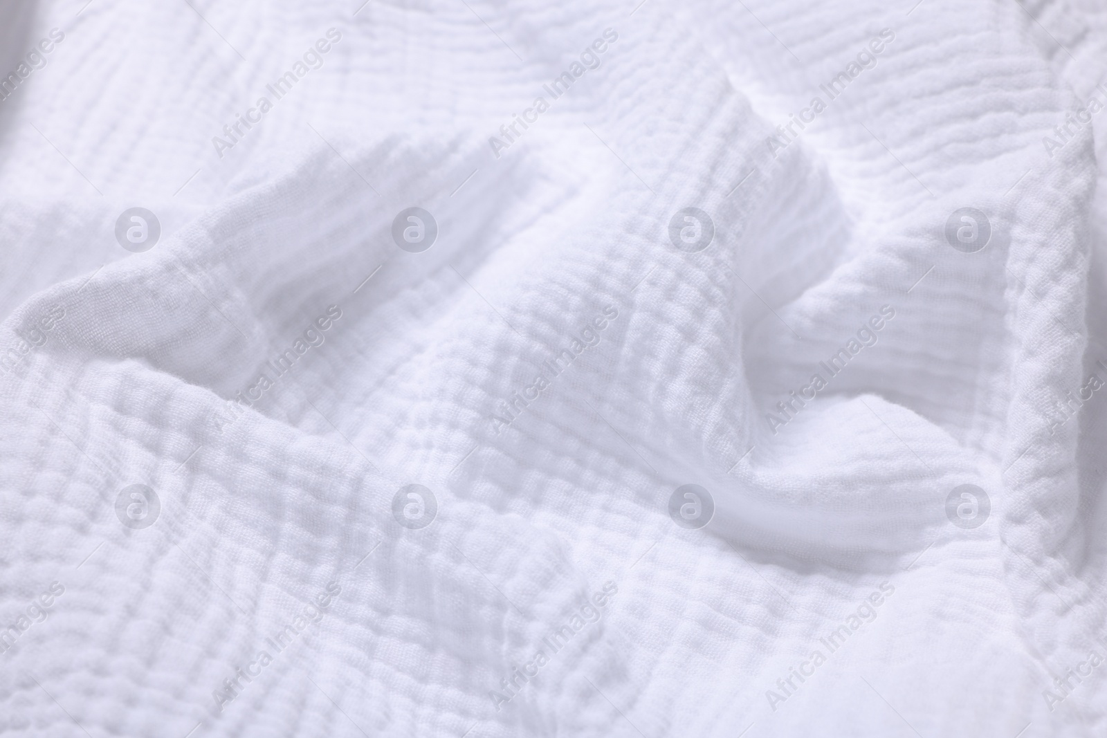 Photo of Texture of white crumpled fabric as background, closeup