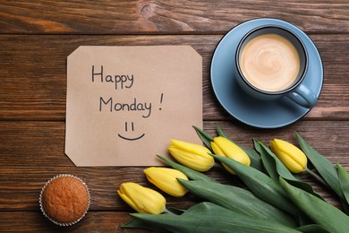 Photo of Happy Monday message, aromatic coffee, cupcake and tulips on wooden table, flat lay