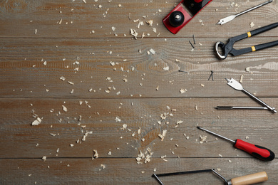 Photo of Flat lay composition with carpenter's tools on wooden background. Space for text