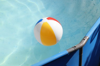 Photo of Inflatable ball on water in above ground swimming pool outdoors