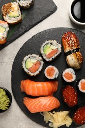 Flat lay composition with delicious sushi rolls on light grey table