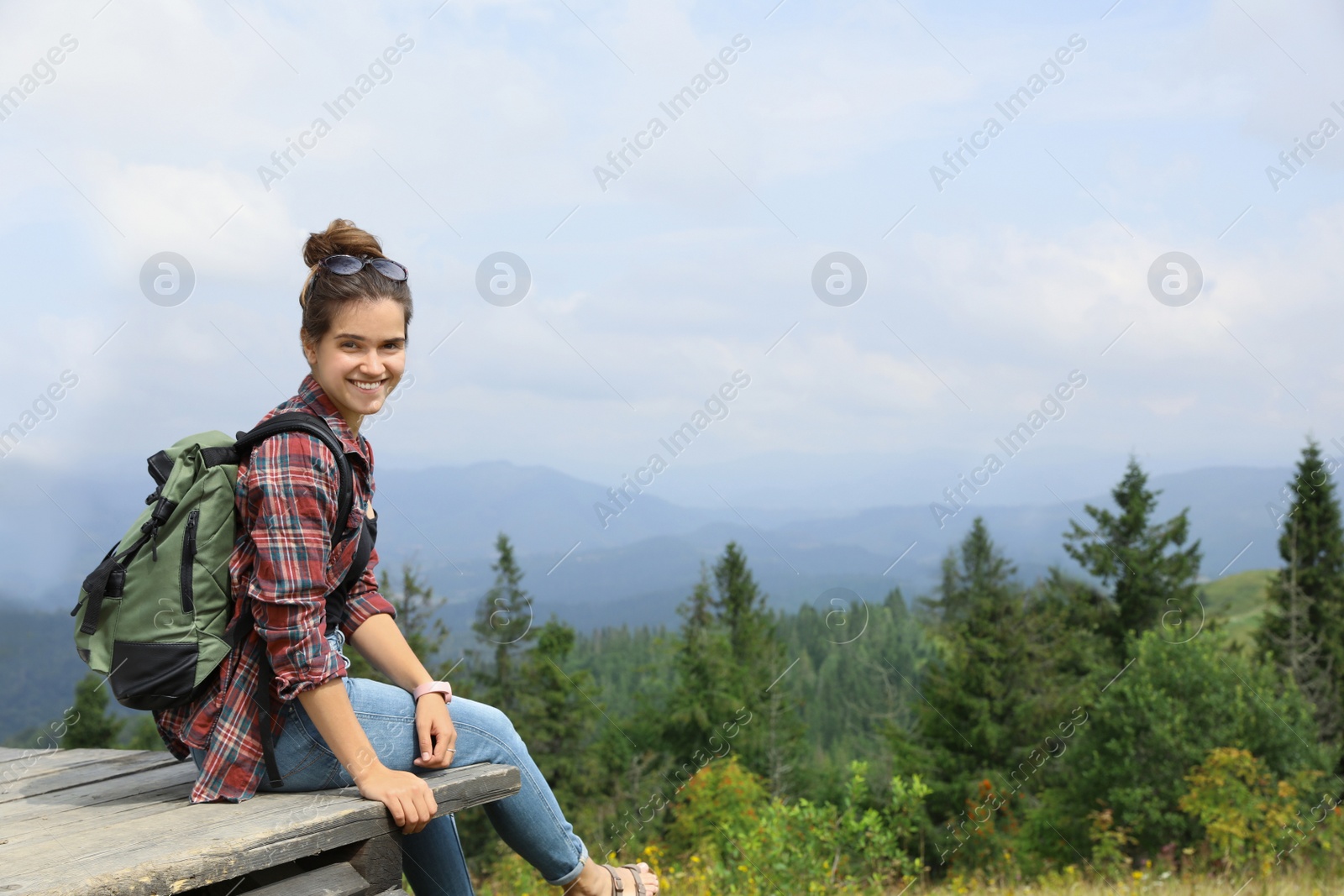 Photo of Woman with backpack in wilderness on cloudy day