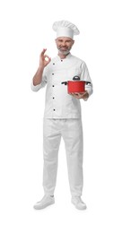 Photo of Happy chef in uniform with cooking pot showing OK gesture on white background