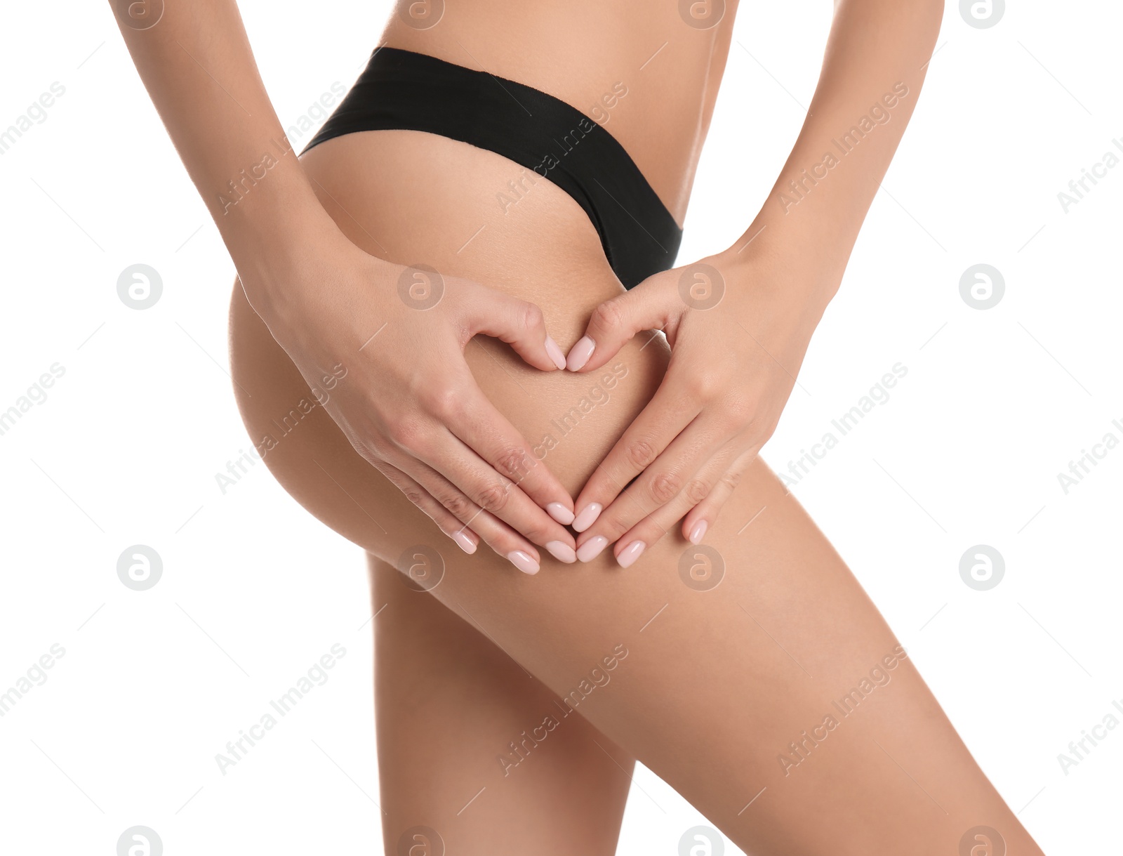 Photo of Closeup view of slim woman in underwear making heart with hands near thigh on white background. Cellulite problem concept