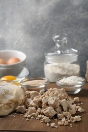 Photo of Different types of yeast, eggs, flour and dough on wooden board