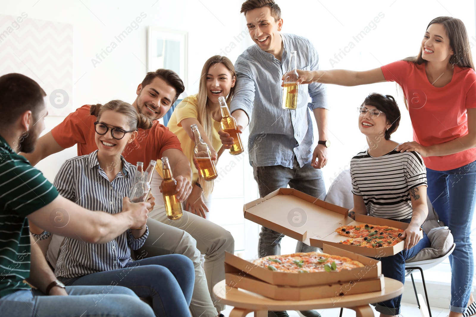 Photo of Young people having fun party with delicious pizza indoors