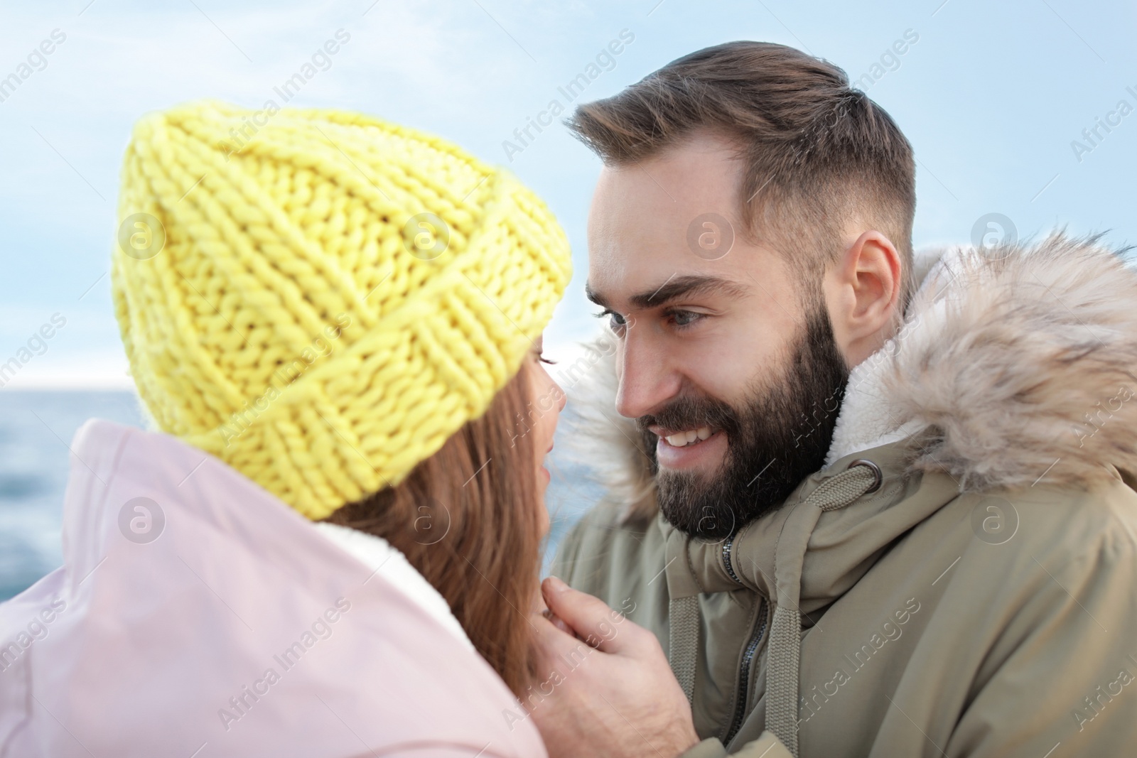 Photo of Lovely young couple holding hands near sea