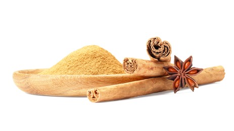 Photo of Dry aromatic cinnamon sticks, powder and anise star isolated on white