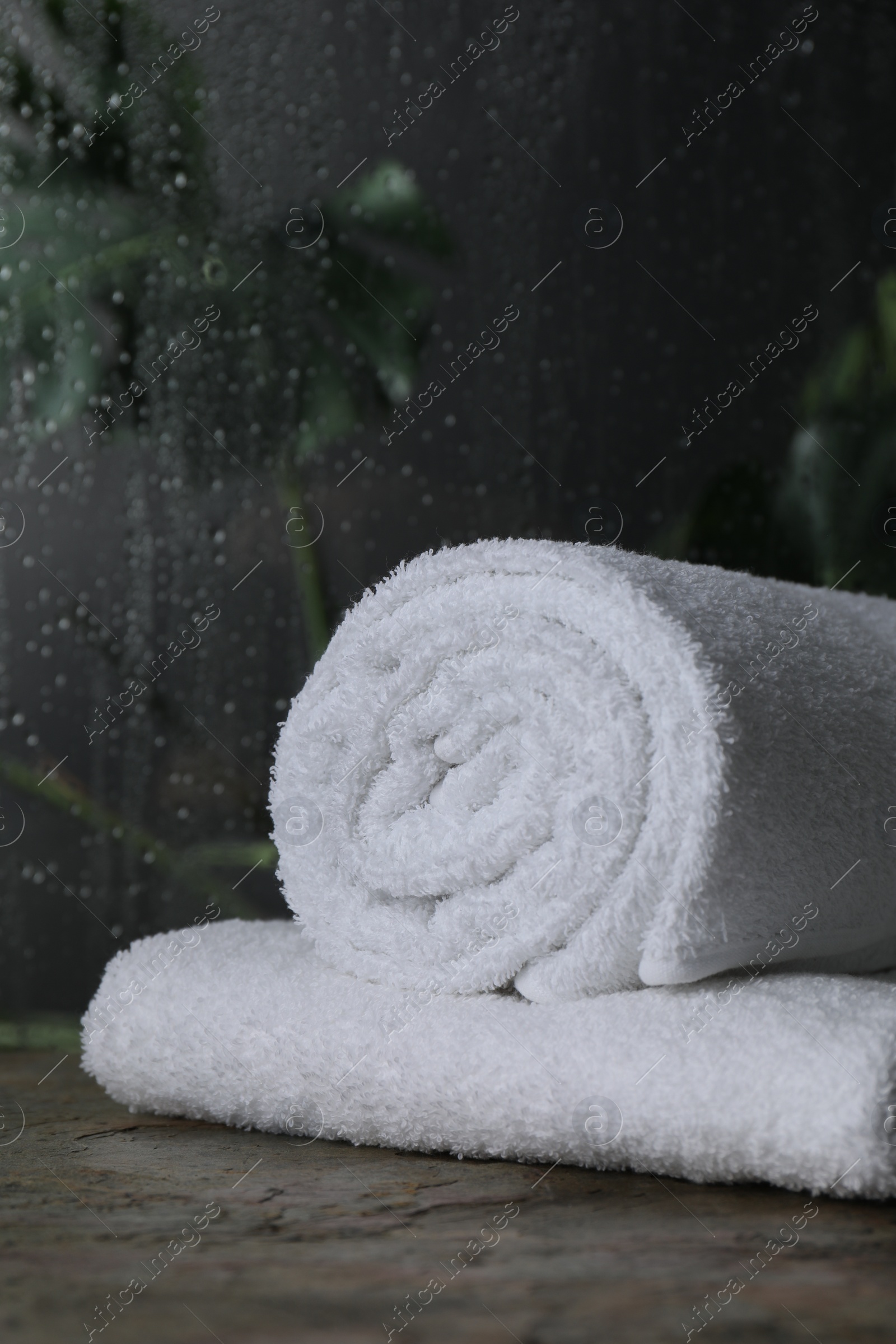 Photo of White terry towels on table in bathroom