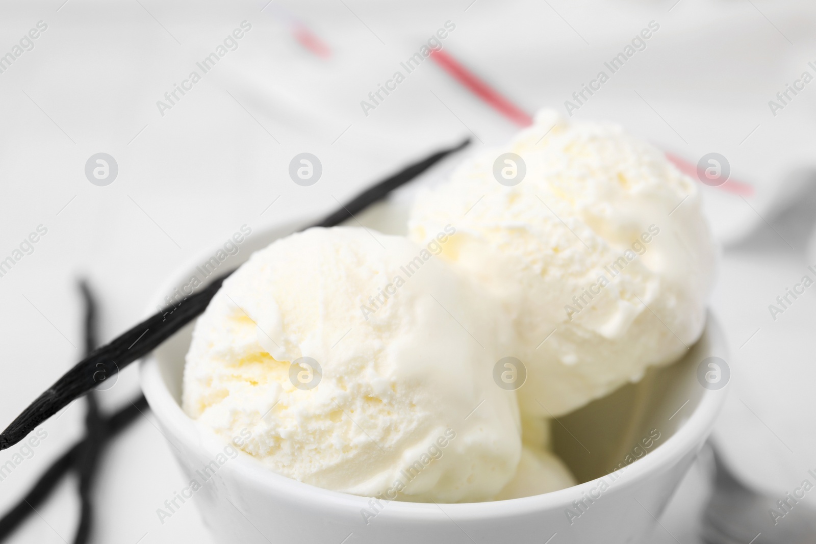 Photo of Delicious vanilla ice cream in bowl, closeup