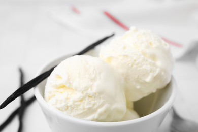 Photo of Delicious vanilla ice cream in bowl, closeup