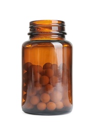 Bottle with vitamin pills on white background