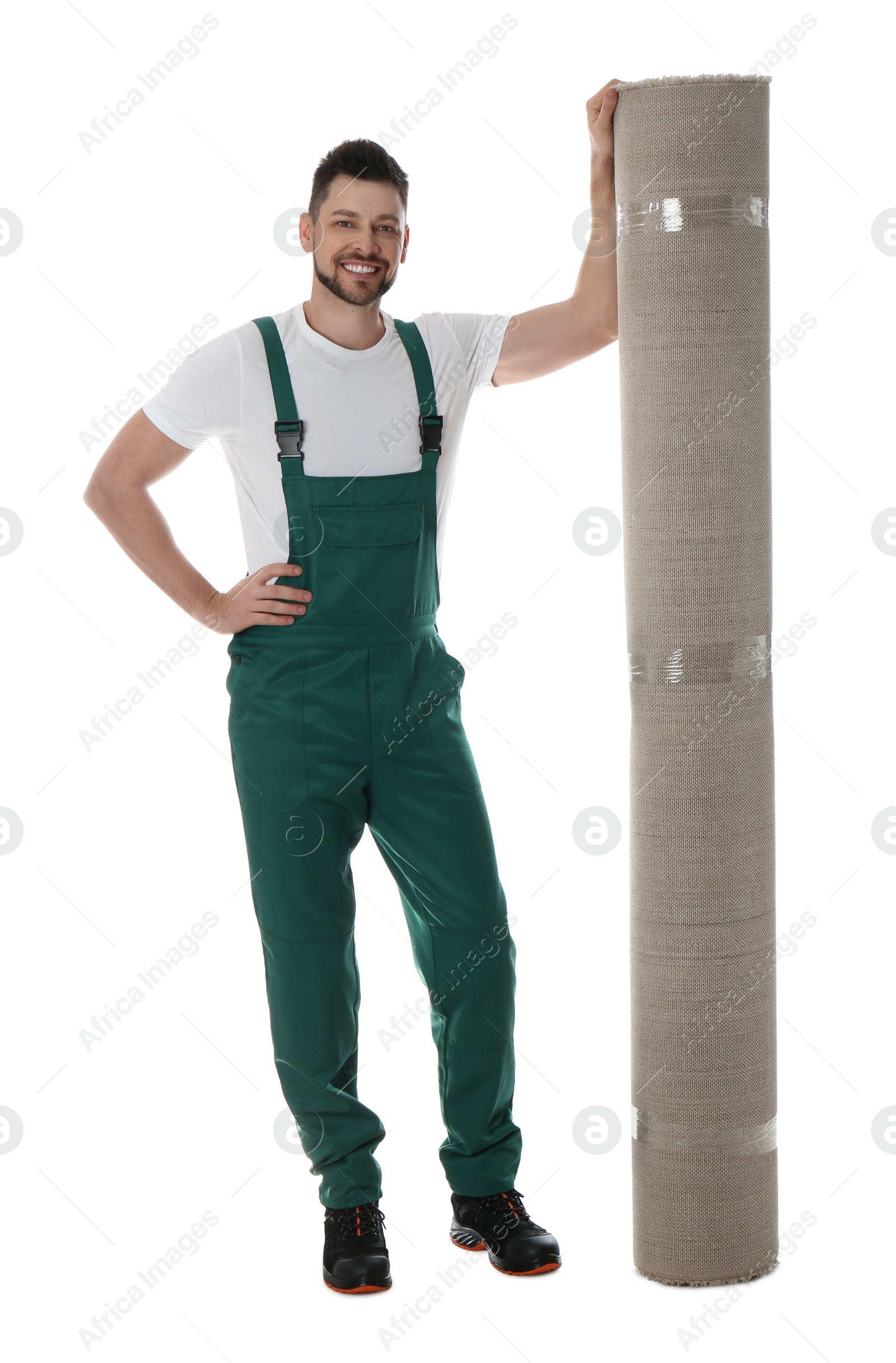 Photo of Male worker with rolled carpet on white background