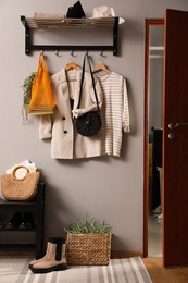 Hallway interior with stylish furniture, clothes and accessories