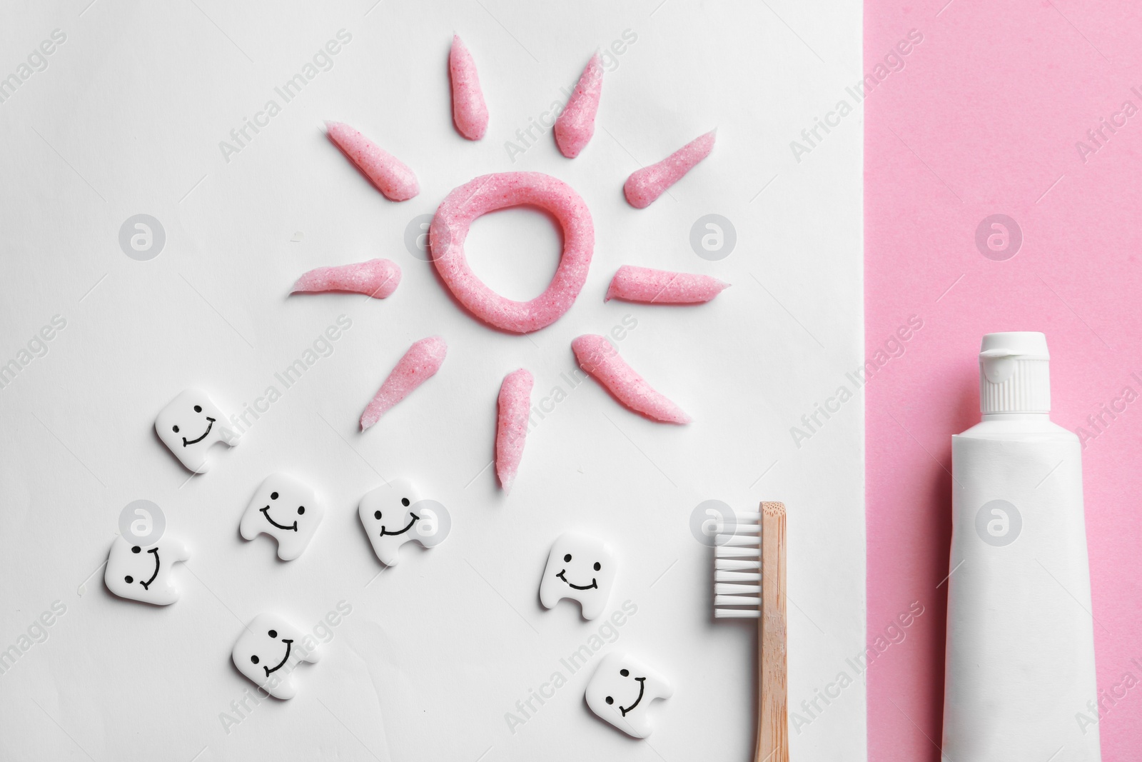 Photo of Flat lay composition with small plastic teeth and paste on color background