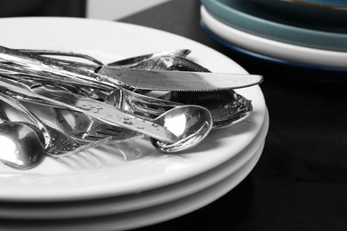 Photo of Different kitchenware after washing on black table, closeup. Space for text