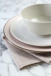 Clean plates, bowl and napkin on table, closeup