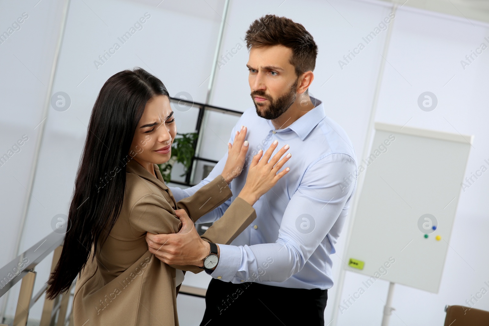 Photo of Young woman fighting with man in office