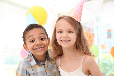 Photo of Cute little children at birthday party indoors