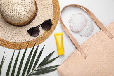 Photo of Flat lay composition with sunscreen and beach accessories on white background