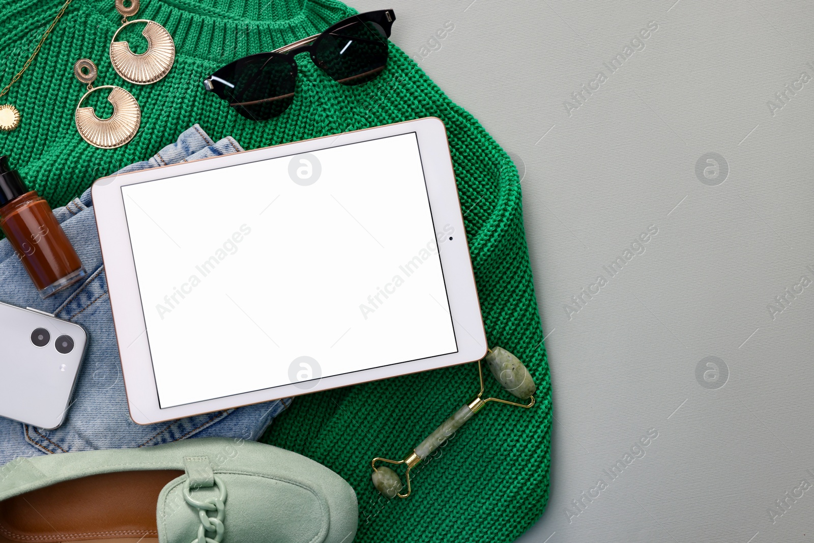 Photo of Flat lay composition with modern tablet on light grey background. Space for text
