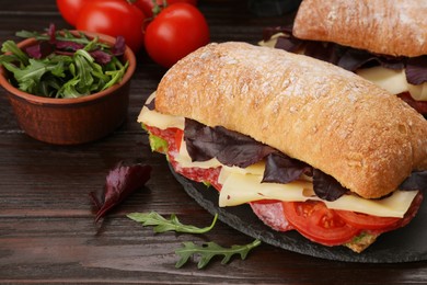 Photo of Delicious sandwiches with cheese, salami, tomato on wooden table, closeup