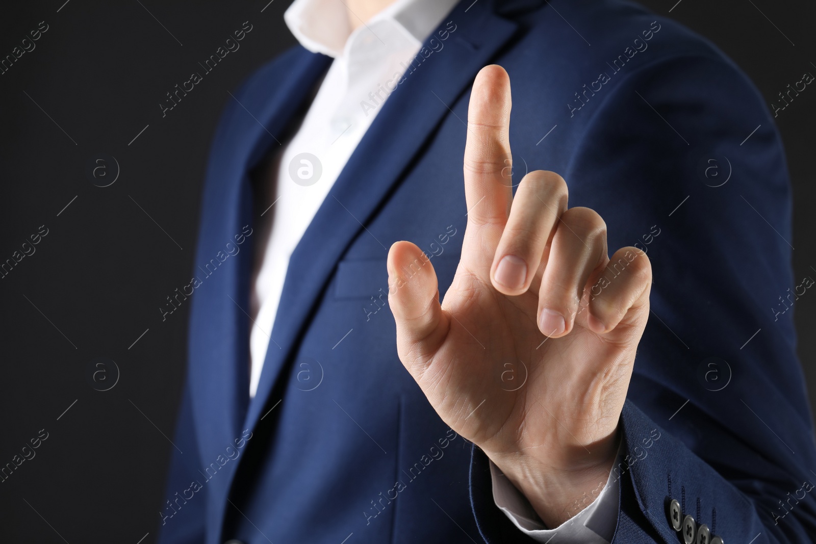 Photo of Man scanning fingerprint on black background, closeup