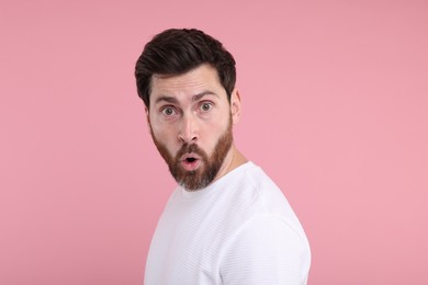 Portrait of surprised man on pink background