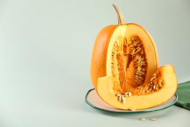 Photo of Cut fresh ripe pumpkin on white background, space for text